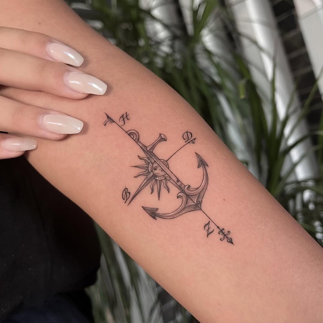 Stylish anchor tattoo with compass and sun