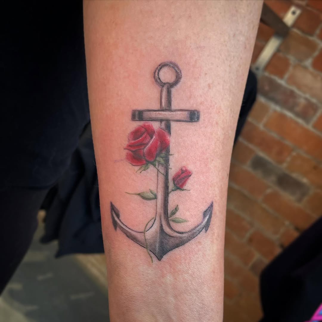 Stylish anchor tattoo adorned with a rose