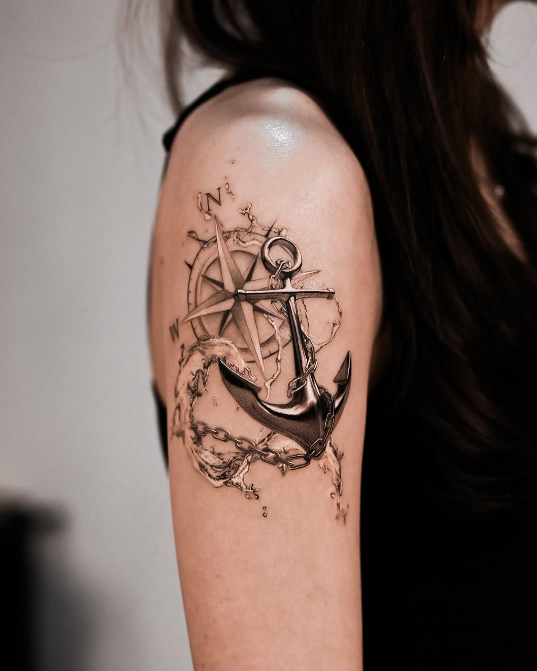 Elegant anchor tattoo with navigational elements
