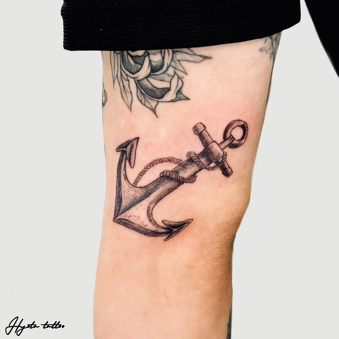 Elegant black ink anchor tattoo on leg