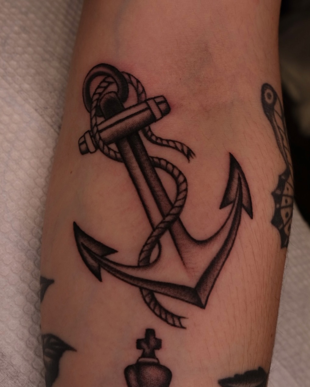 Intricately detailed anchor tattoo with rope