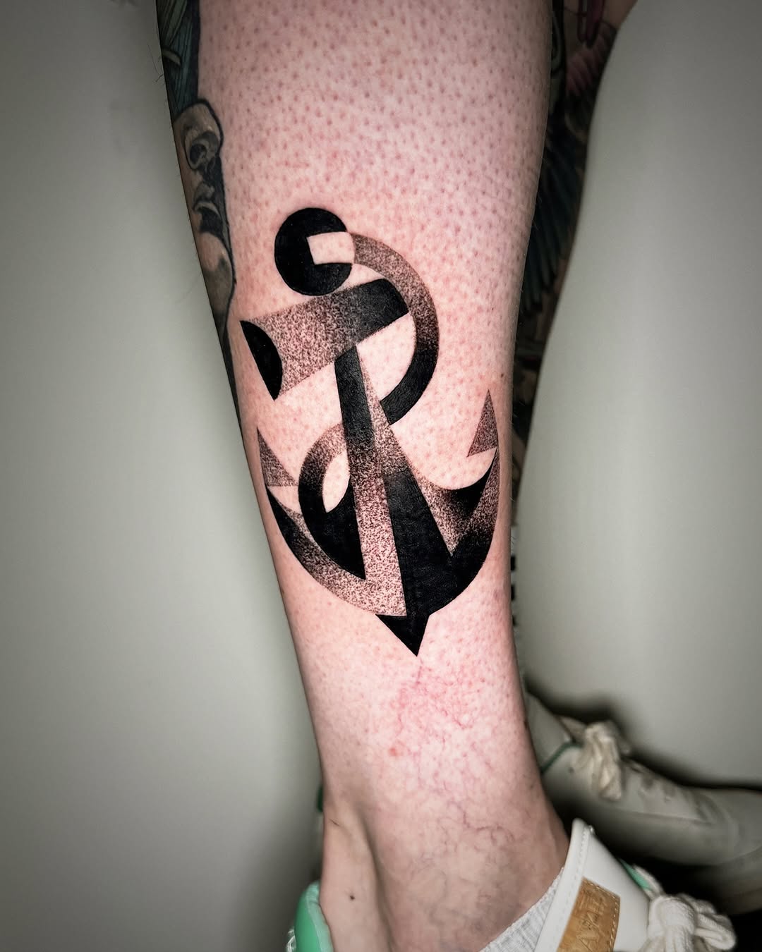 Stylish anchor tattoo in black and grey