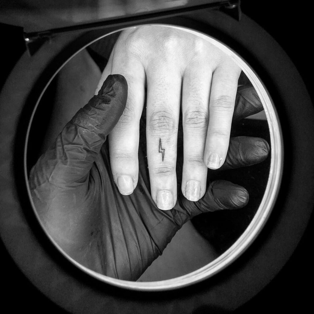 Small Lightning Bolt Finger Tattoo