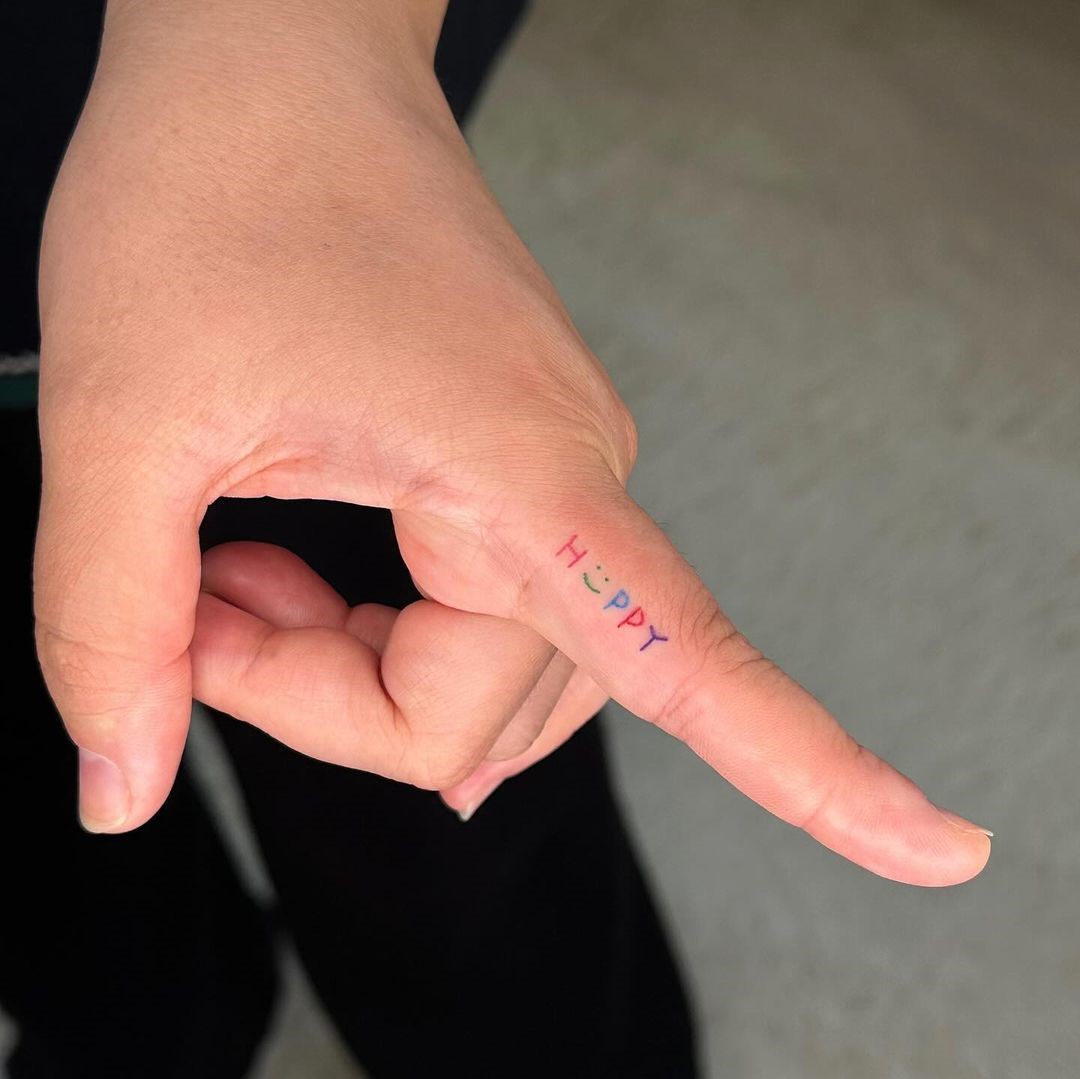 “Happy” Finger Tattoo