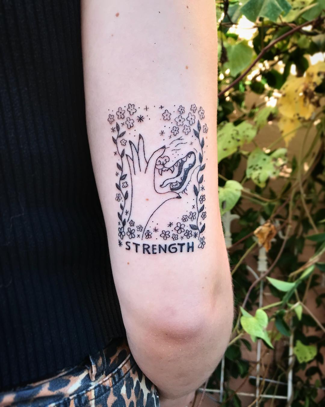 Nature-Inspired Strength Tattoo Design
