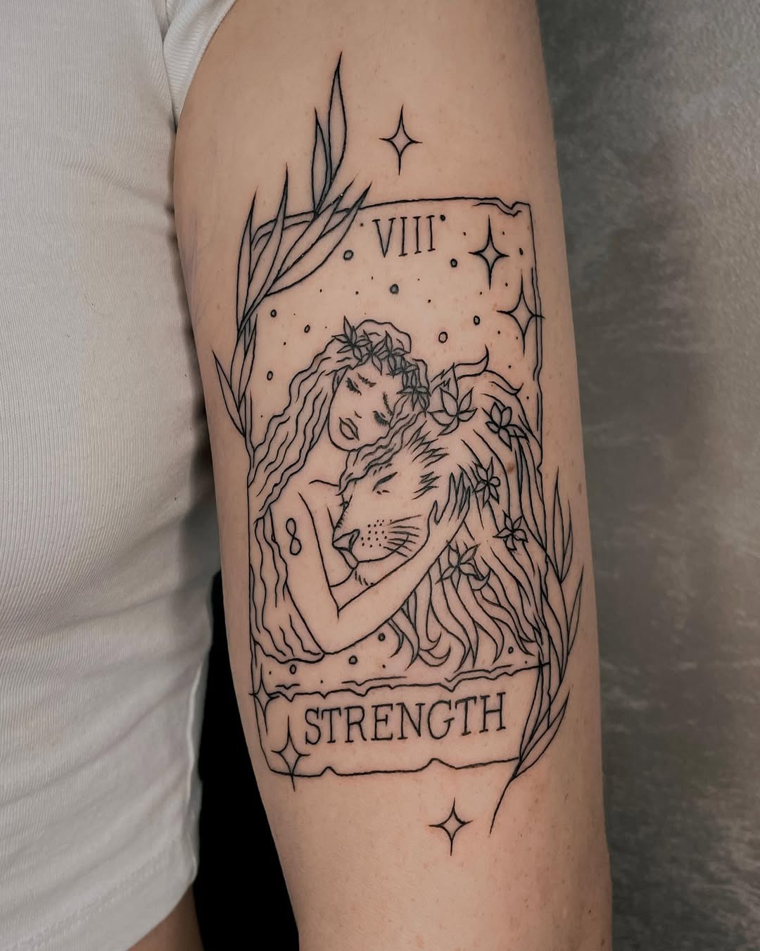 Elegant strength tattoo merging nature and power