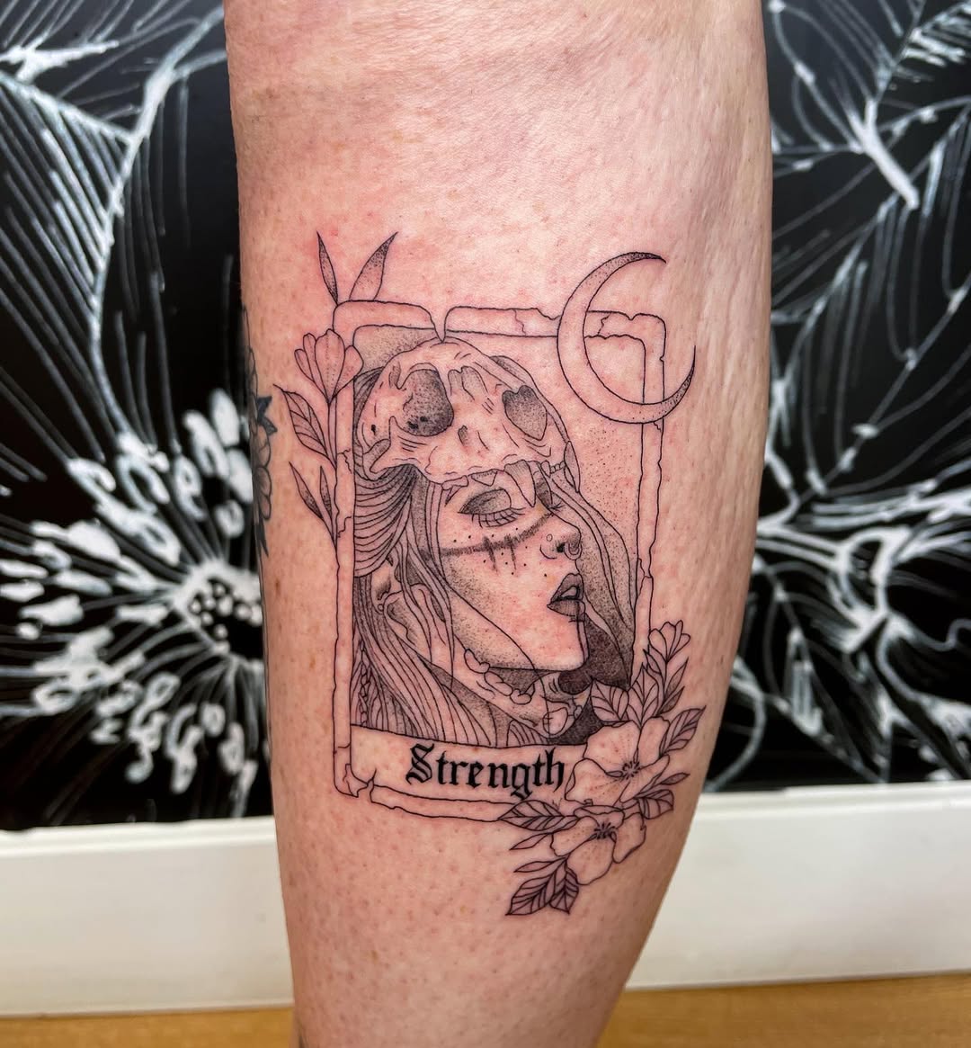Feminine strength tattoo with floral elements