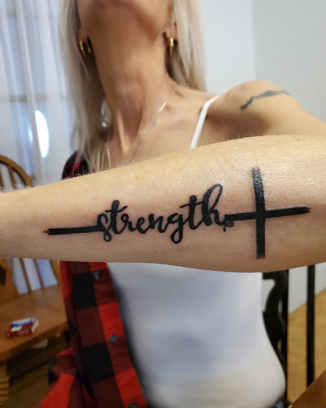 Bold 'Strength' Tattoo with Cross Design
