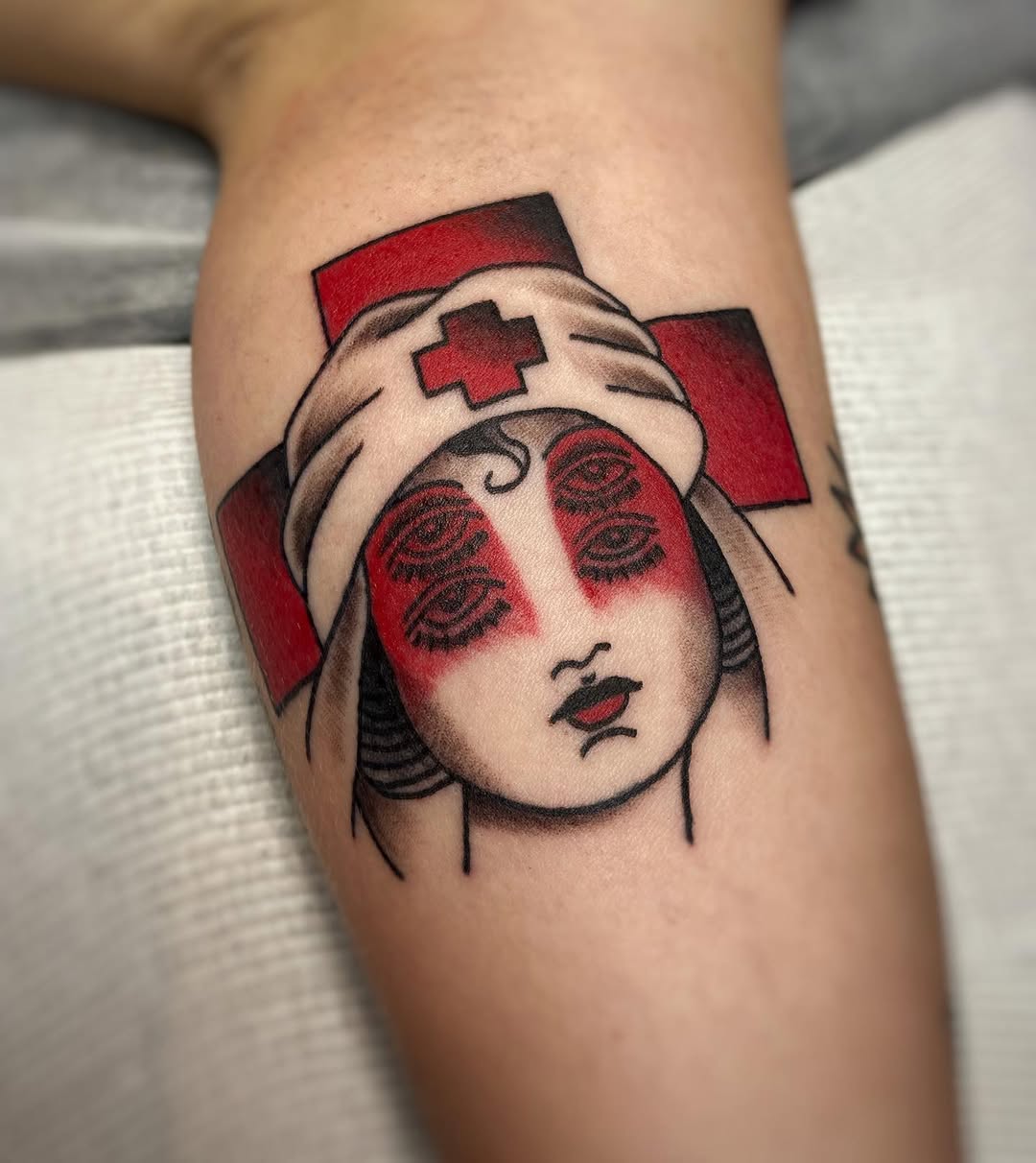 Striking Nurse Tattoo with Red Cross Elements