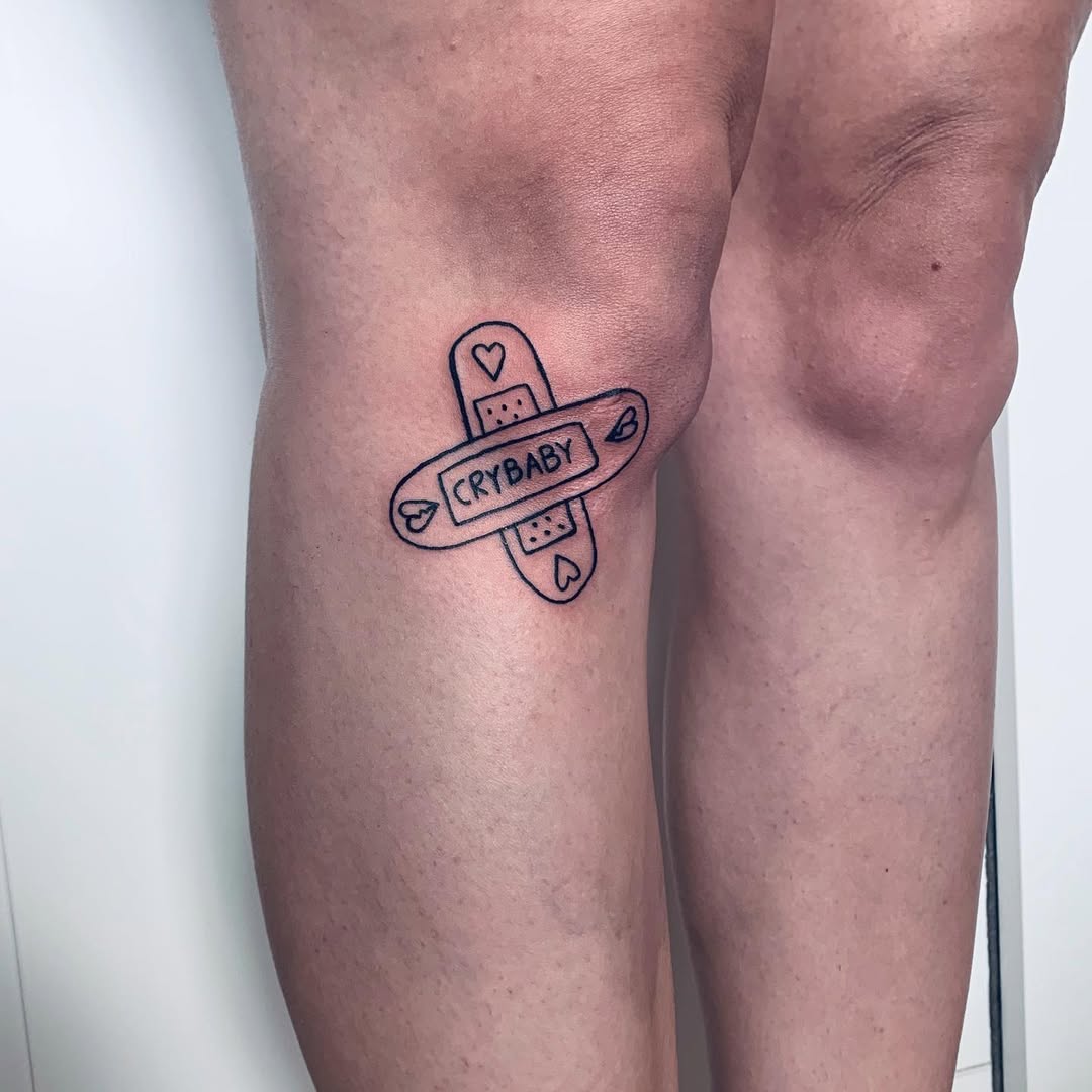 Playful bandaid tattoo embodying self-love