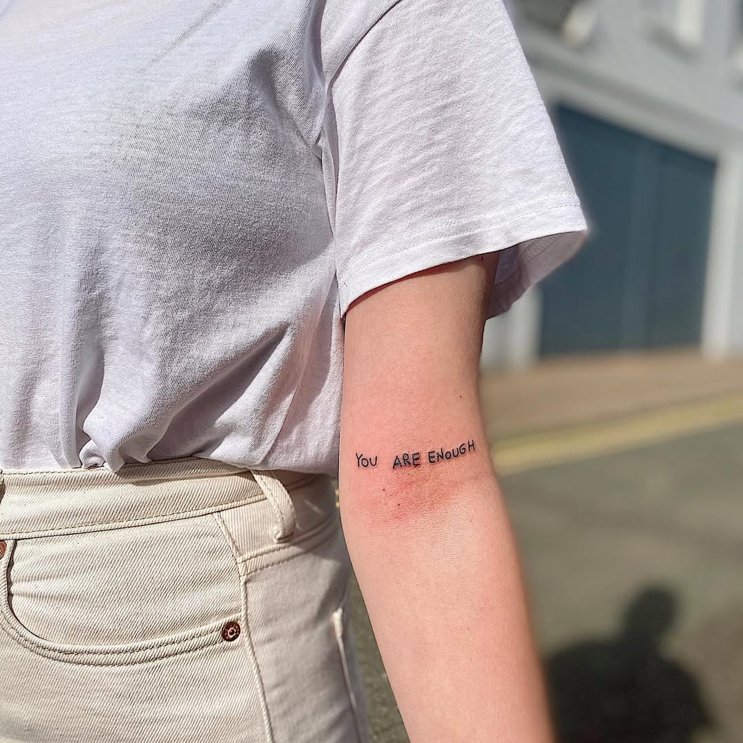 Empowering affirmation tattoo on the arm