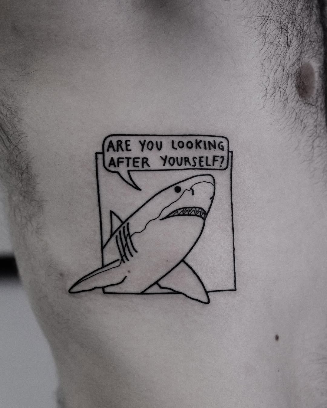 Quirky shark tattoo promoting self-care message