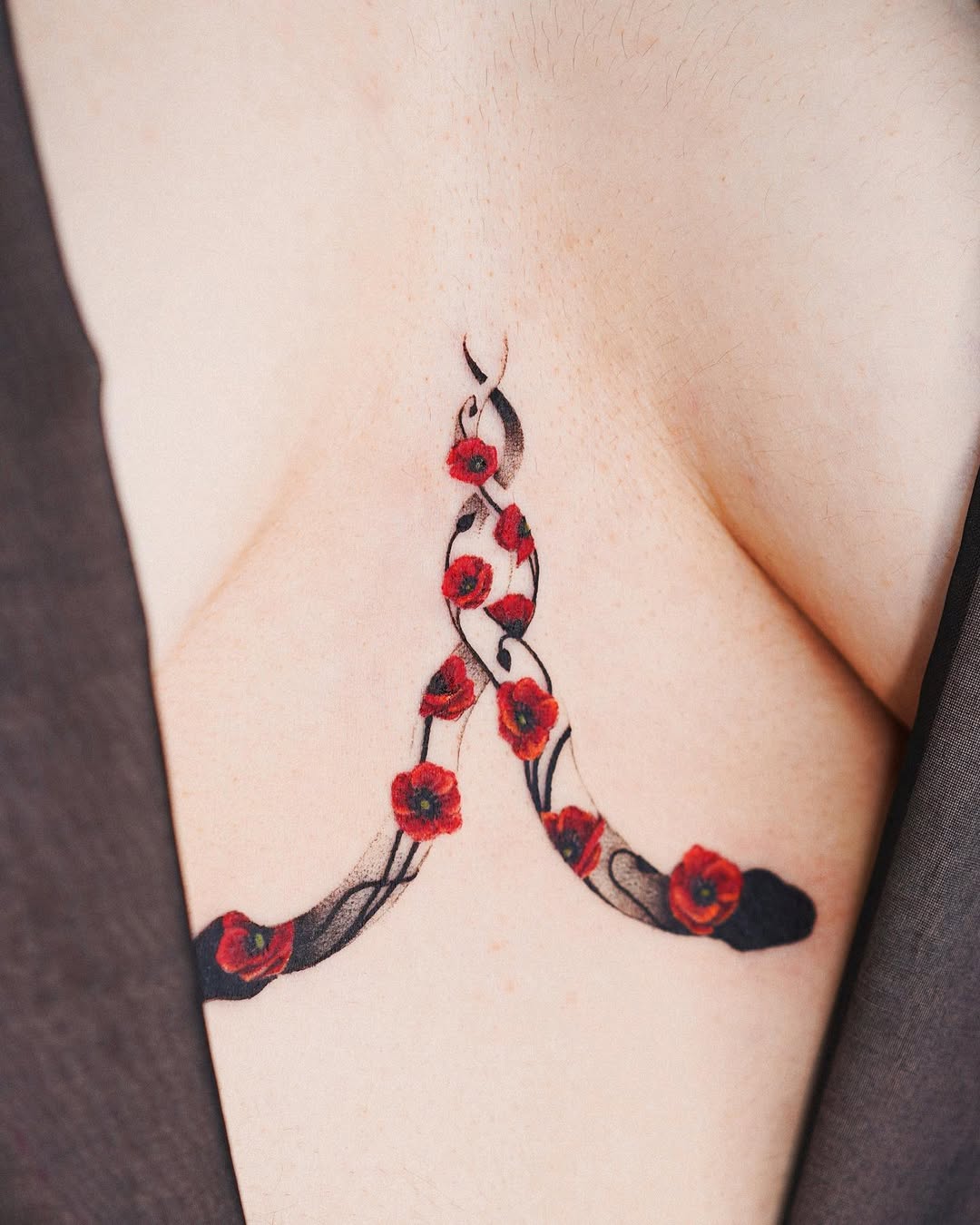 Elegant underboob tattoo with red roses