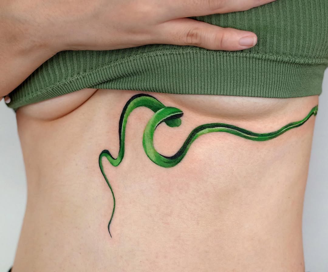 Captivating green snake underboob tattoo design