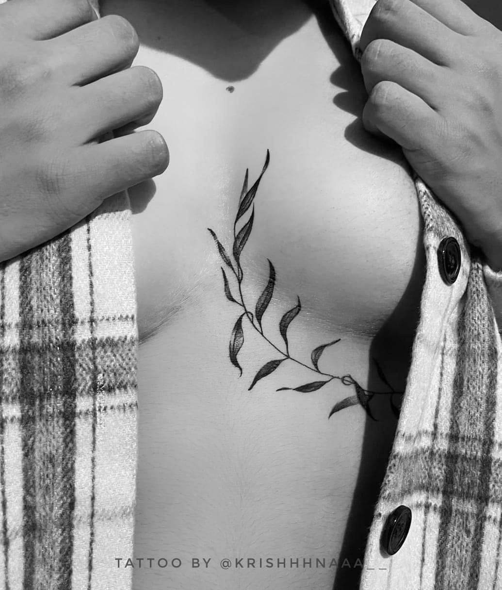 Elegant underboob tattoo with floral motifs