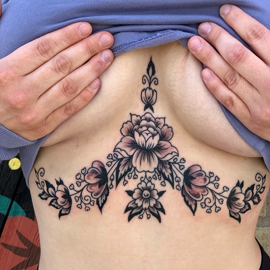 Elegant floral underboob tattoo with intricate details