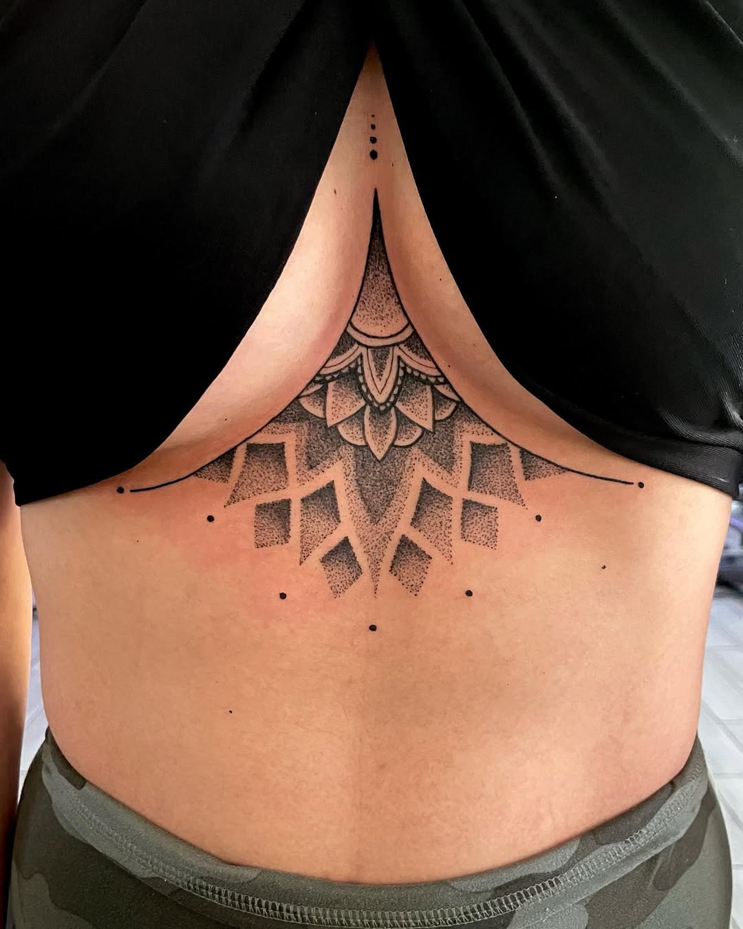 Elegant geometric underboob tattoo design inspiration