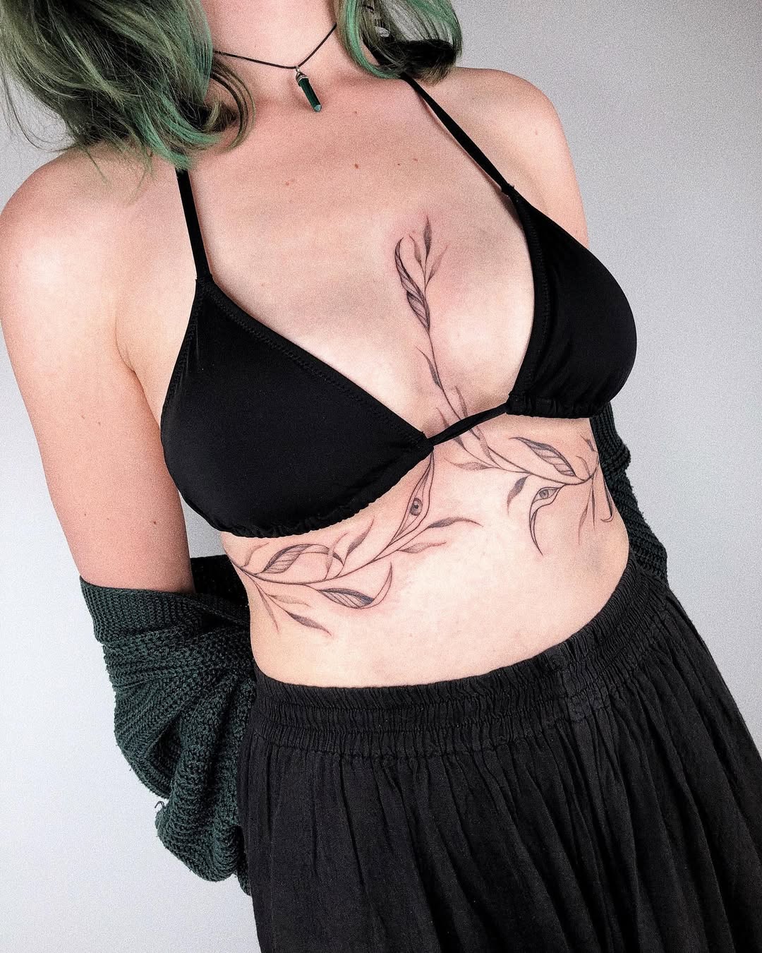 Stylish underboob tattoo featuring floral motifs