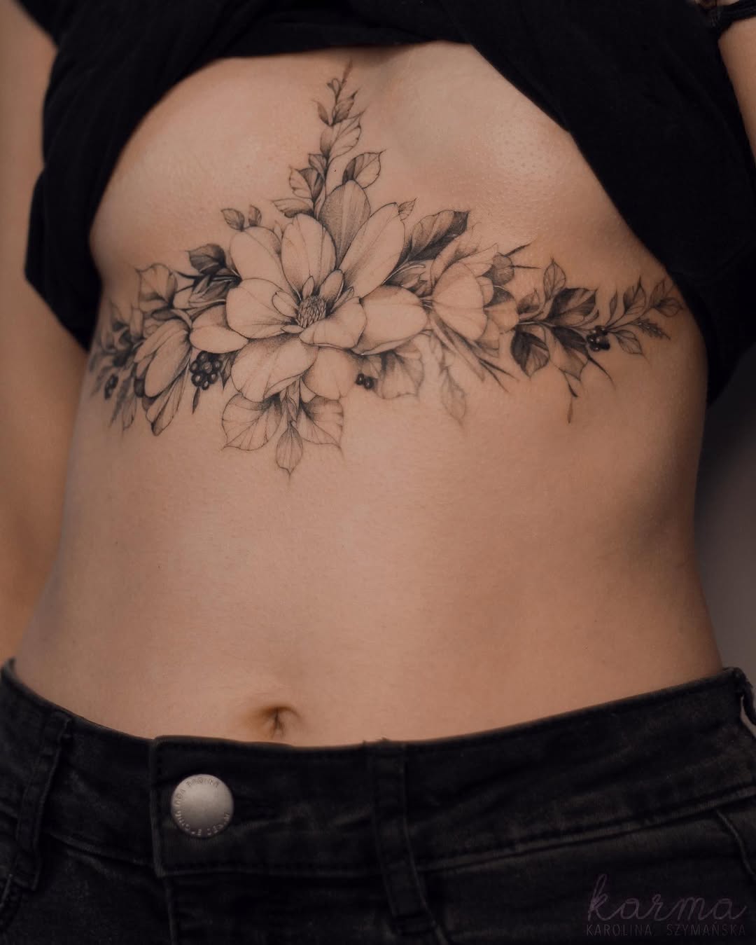 Elegant floral underboob tattoo design