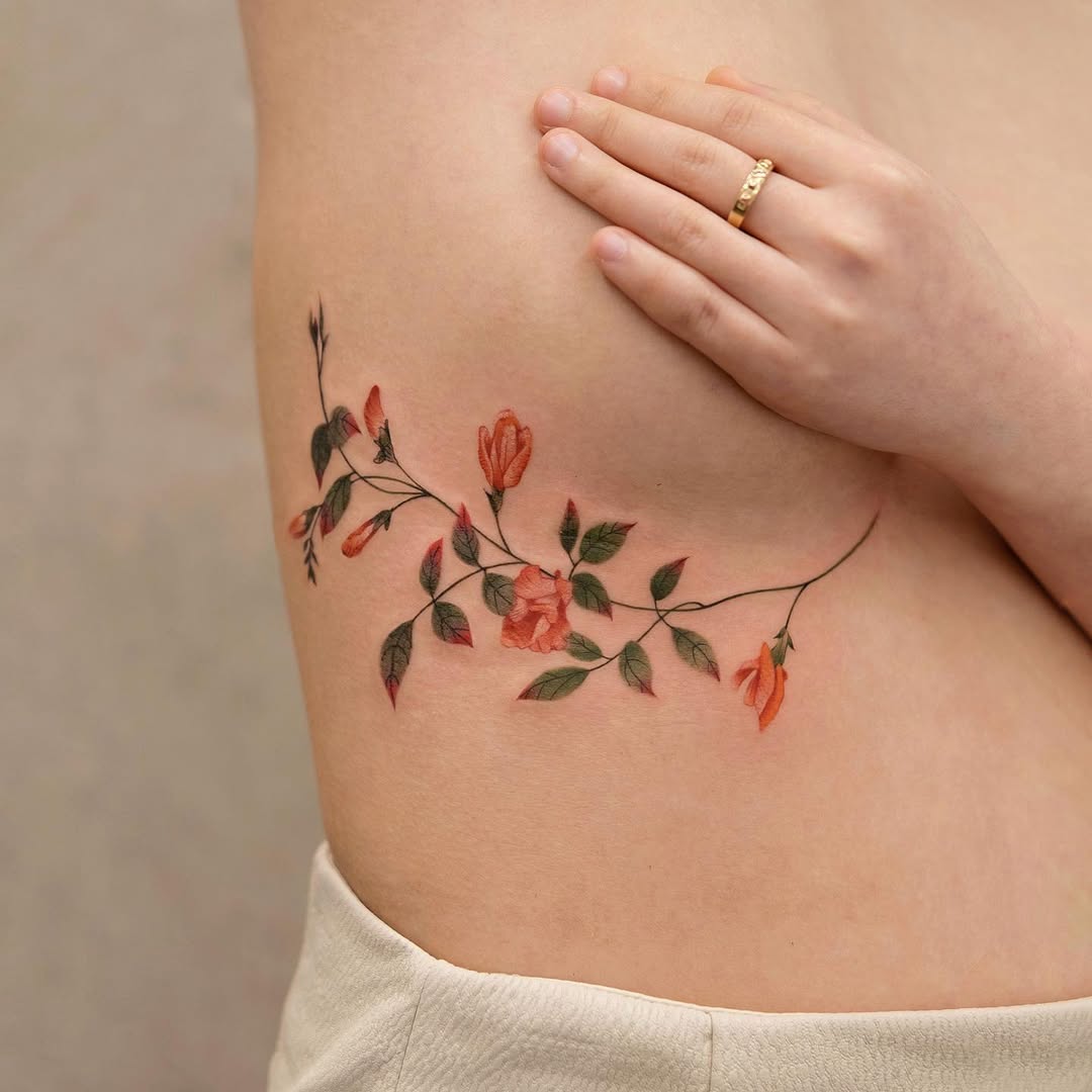 Elegant floral underboob tattoo design and placement