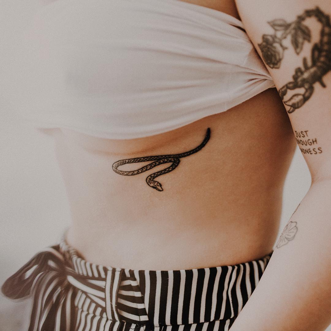 Elegant snake underboob tattoo design