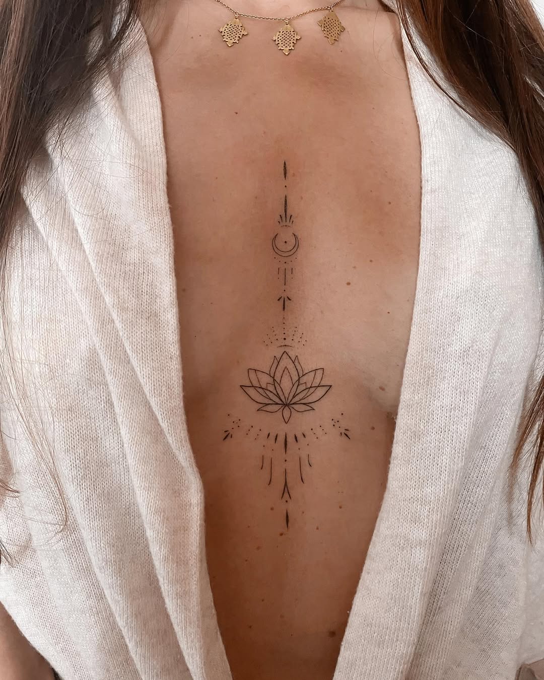 Elegant underboob tattoo with lotus and moon