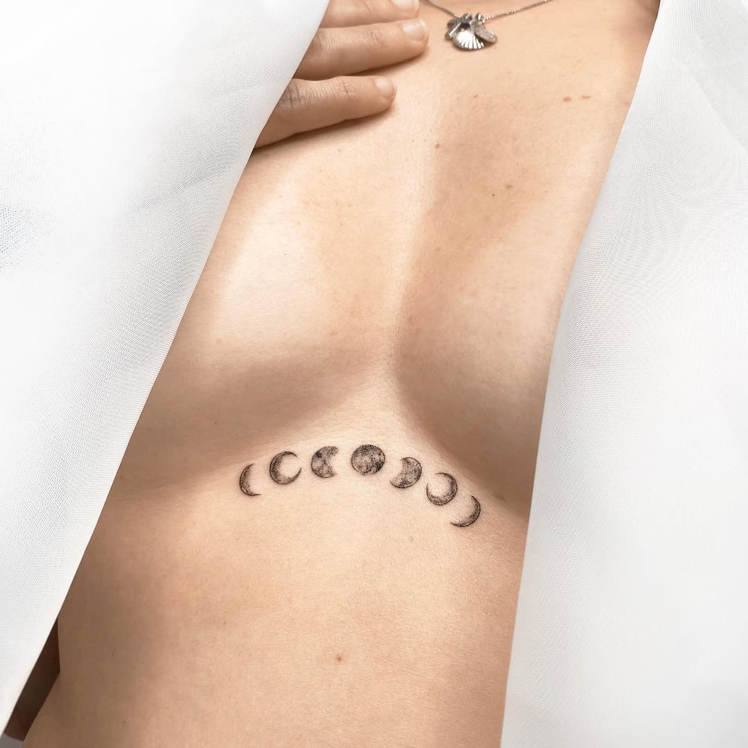 Elegant moon phase underboob tattoo design