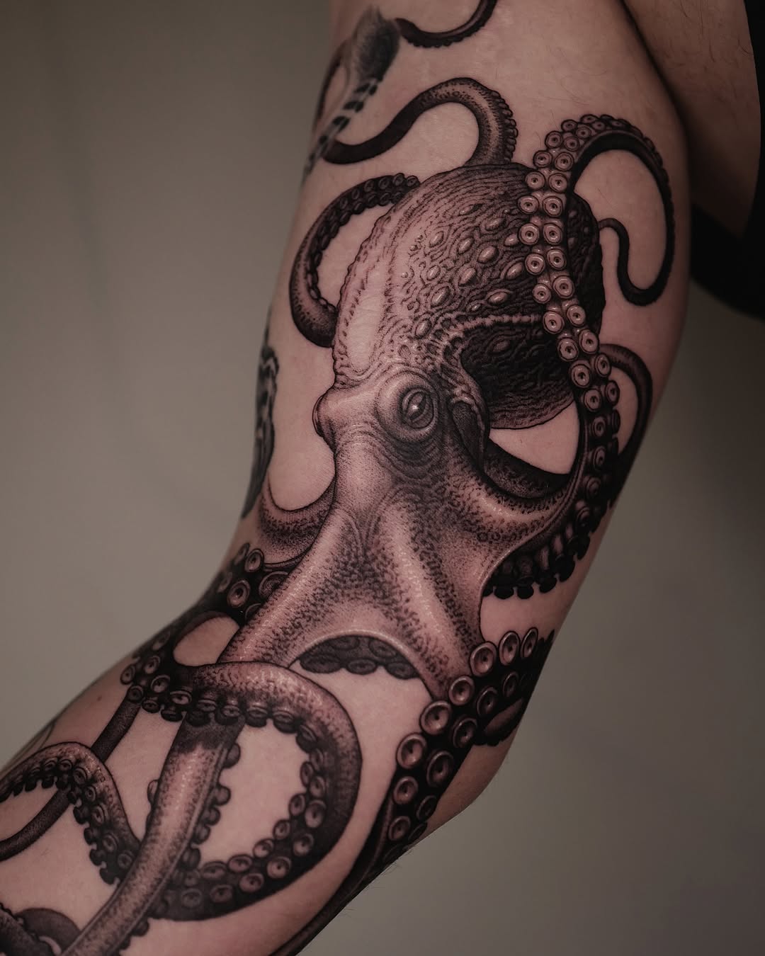 Intricate Black Ink Octopus Arm Tattoo Design