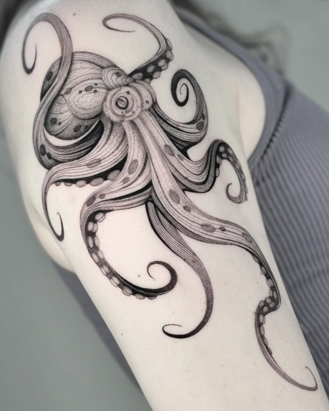 Intricate black ink octopus tattoo on arm