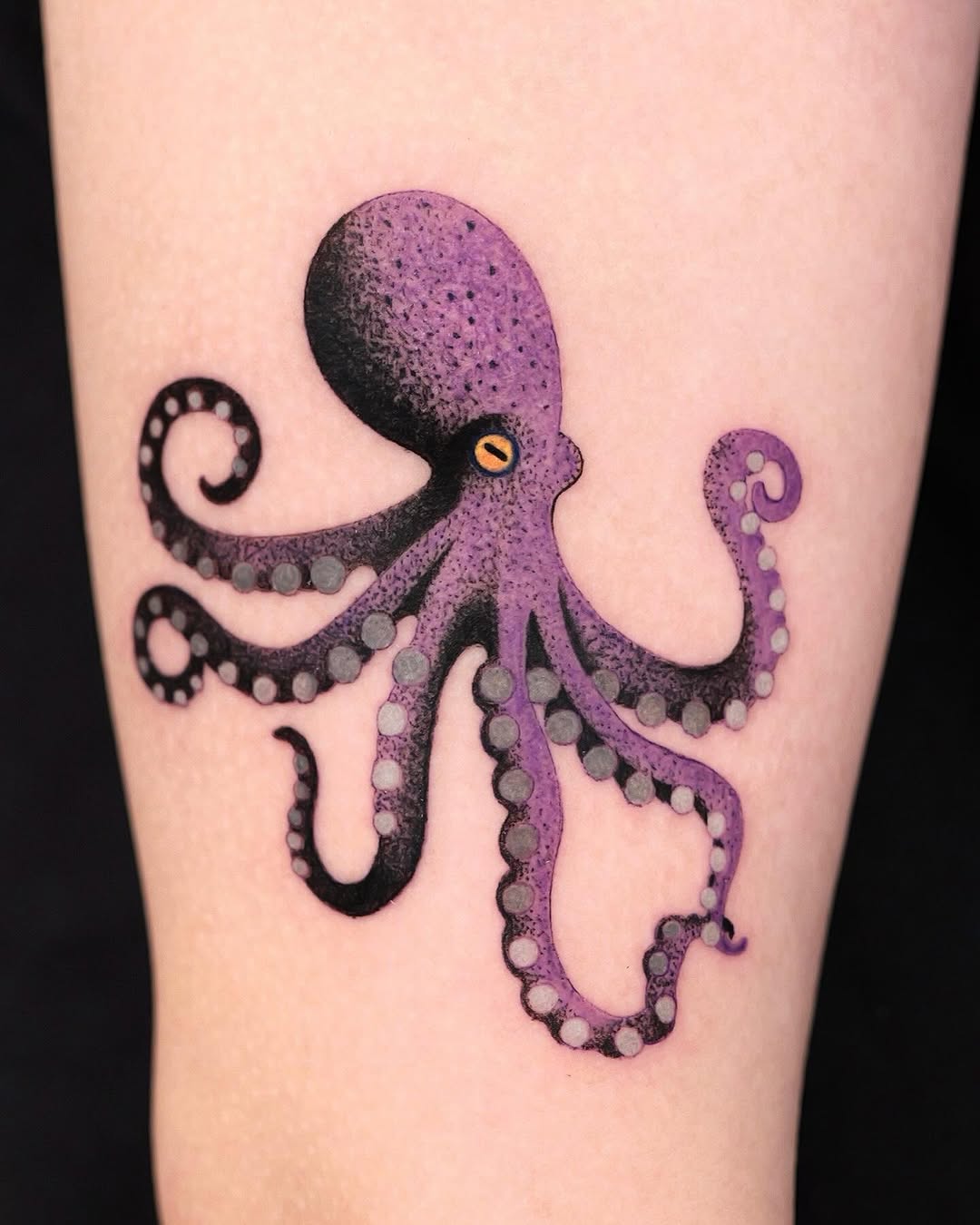 Vibrant purple octopus tattoo with flowing tentacles