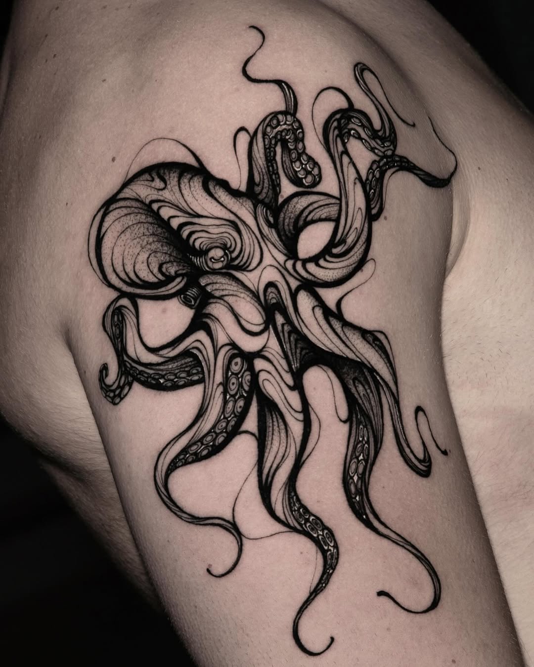 Intricate black ink octopus tattoo on shoulder