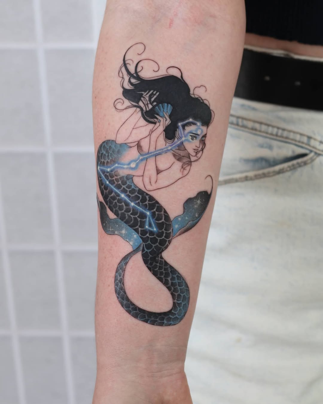 Enchanting mermaid tattoo blending beauty and mystery