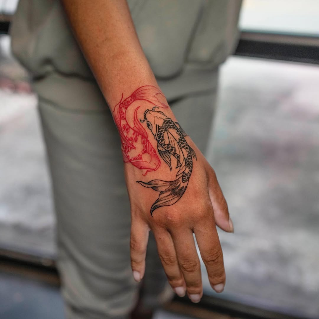 Striking Pisces tattoo with red and black elements