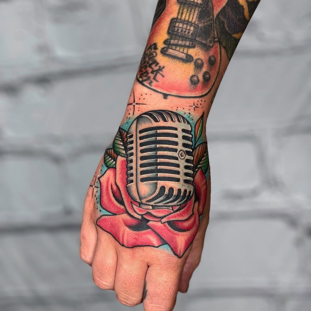 Vibrant microphone tattoo intertwined with roses