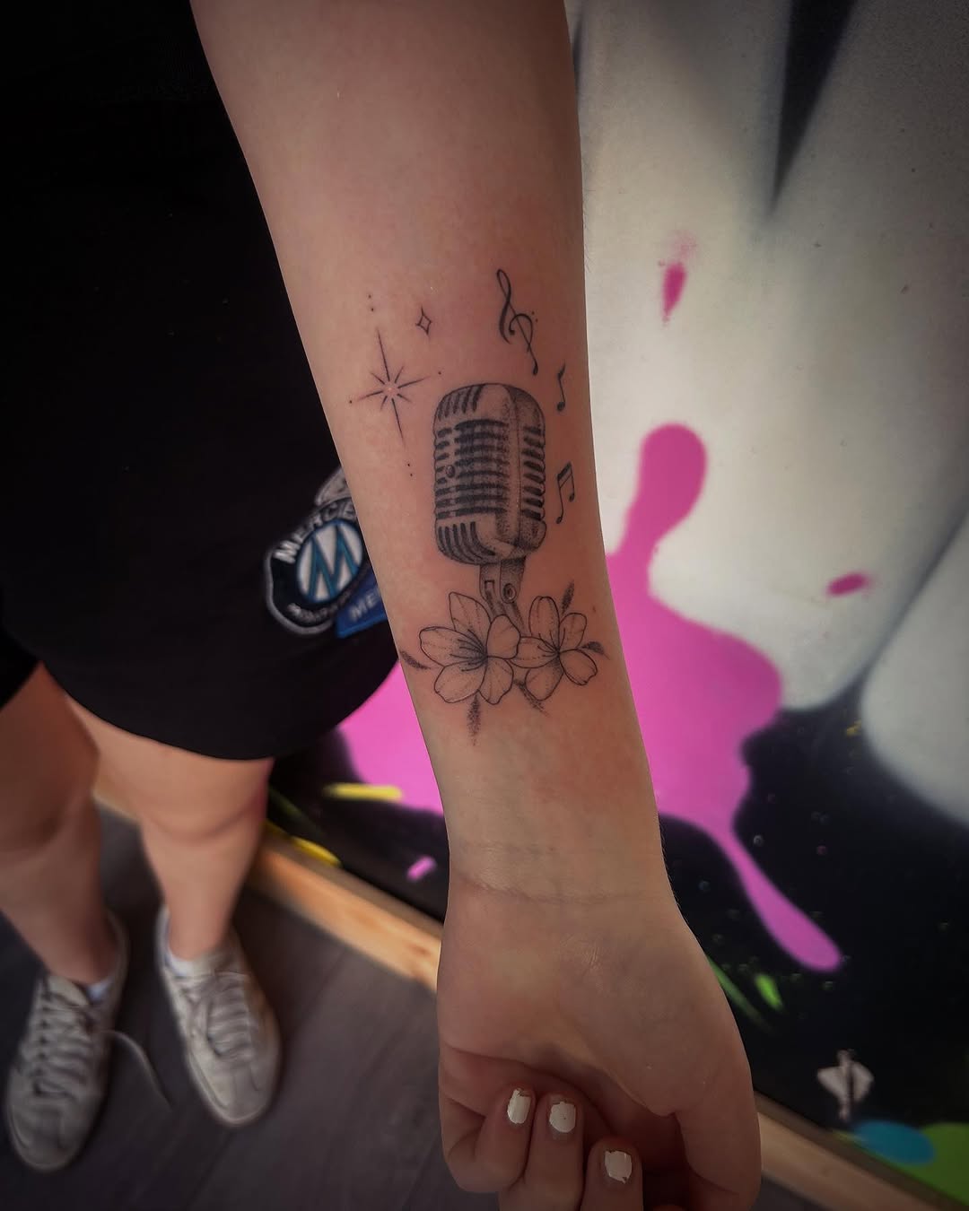 Tattoos blending music and nature beautifully.