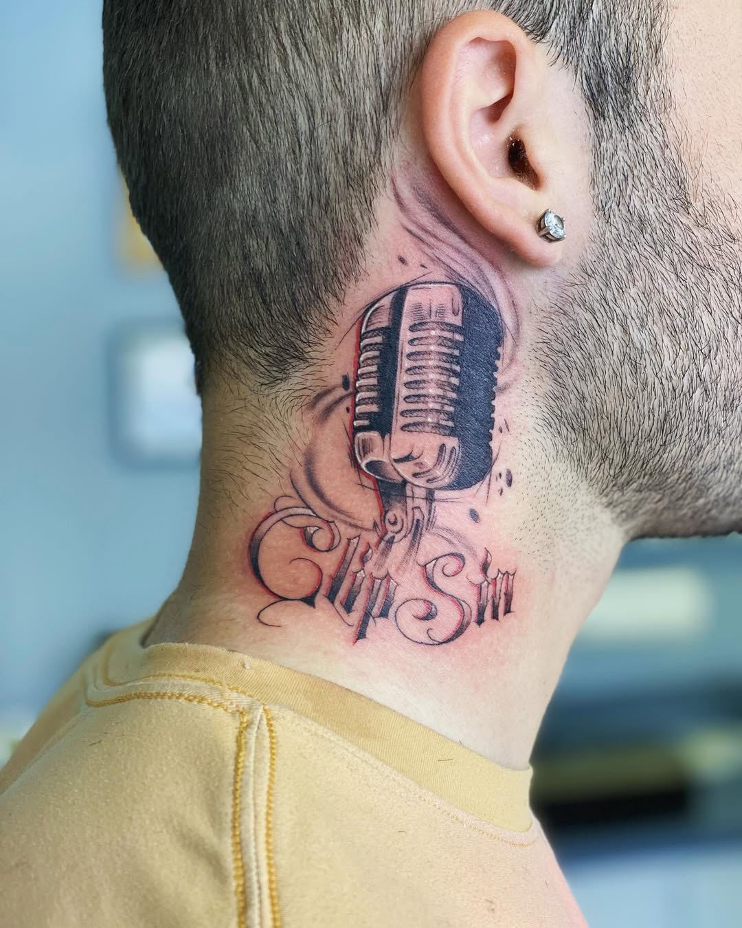 Stylish microphone tattoo on the neck