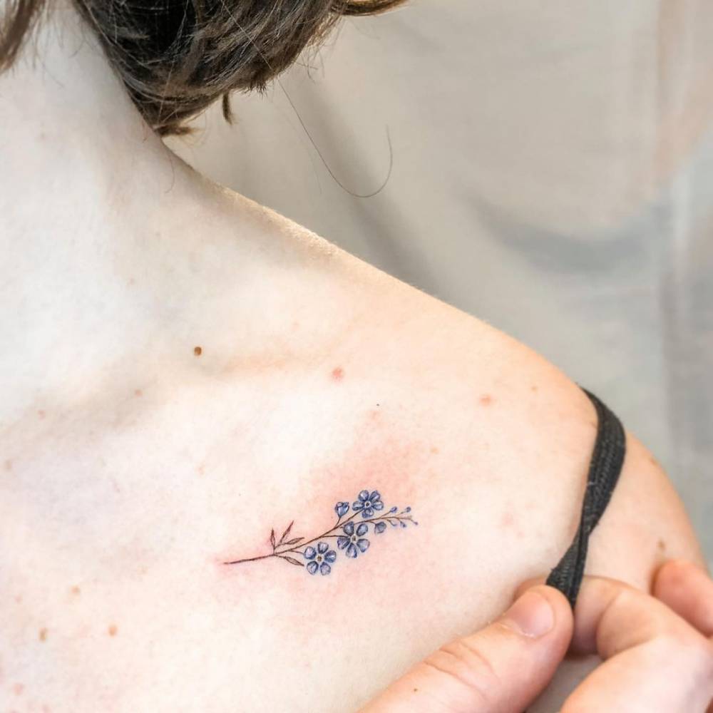 Forget-me-not flower tattoo on shoulder.