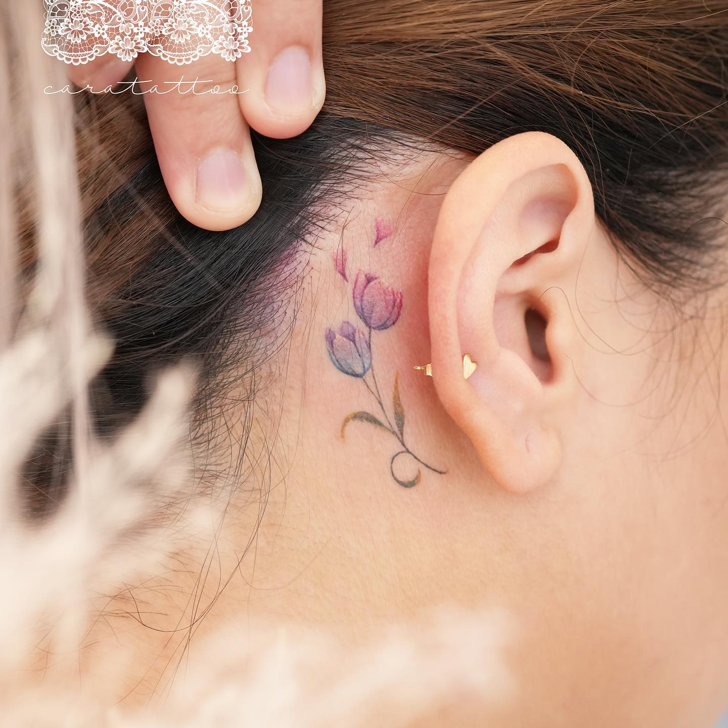 tiny flower behind the ear