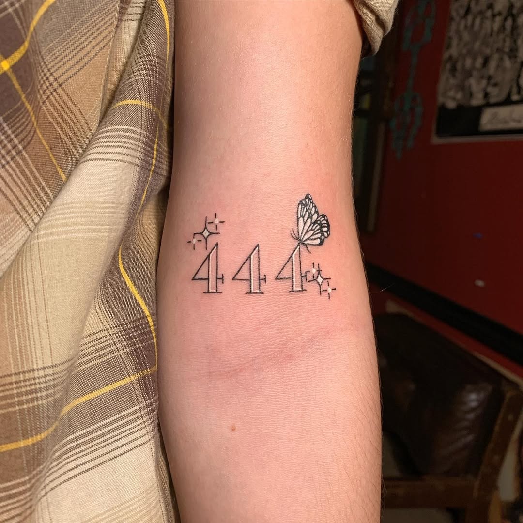 Minimalistic 444 tattoo with a butterfly design