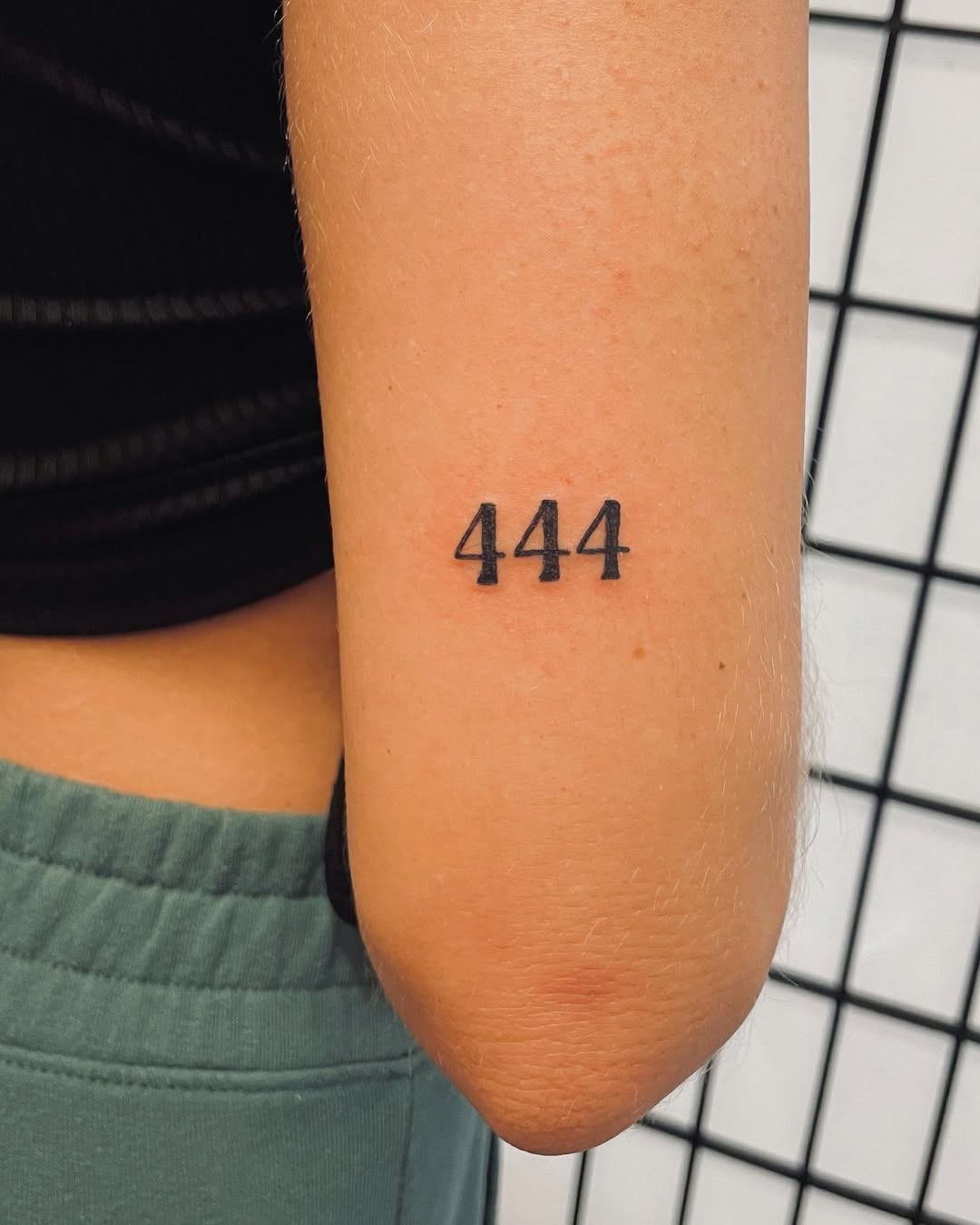 Bold 444 tattoo in minimalist style