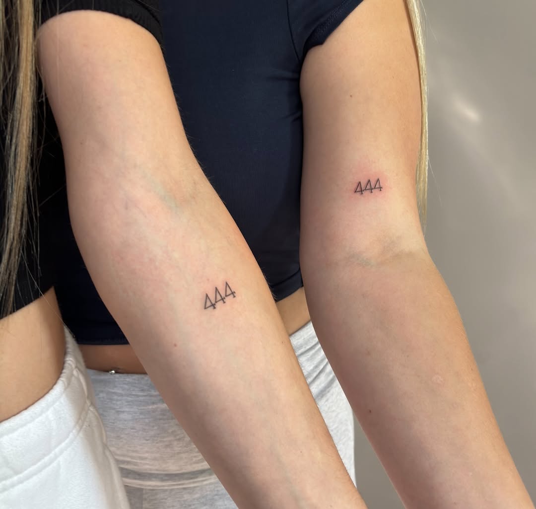 Symbolic 444 tattoos on arms of sisters
