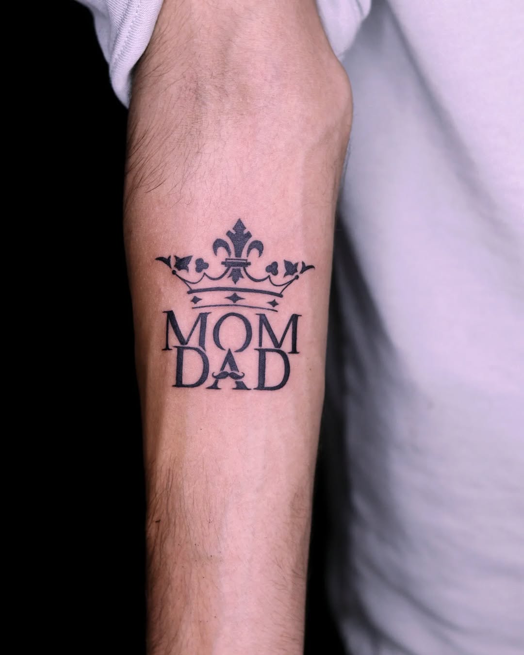 Elegant crown tattoo tribute to mom and dad