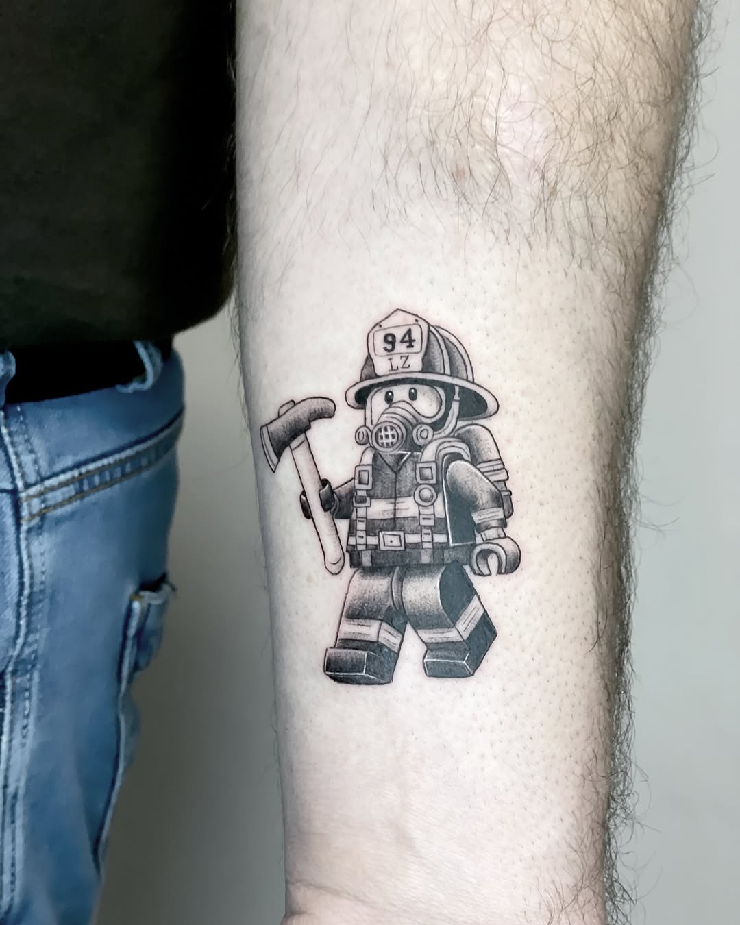 Creative LEGO-inspired firefighter tattoo design