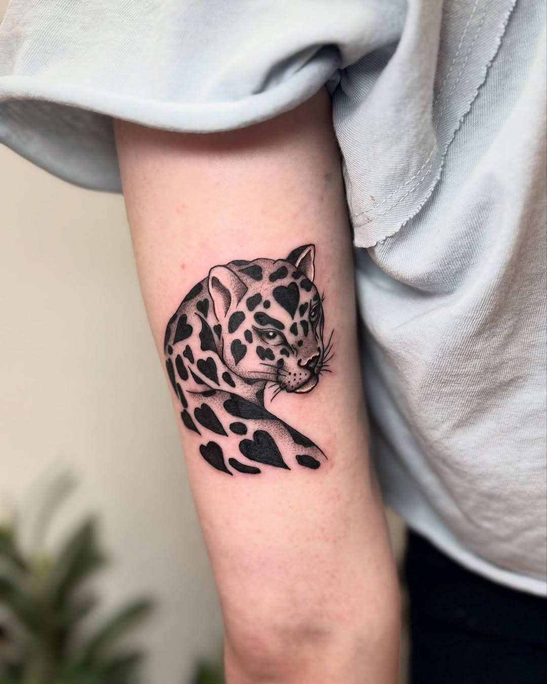 Realistic leopard tattoo design on arm