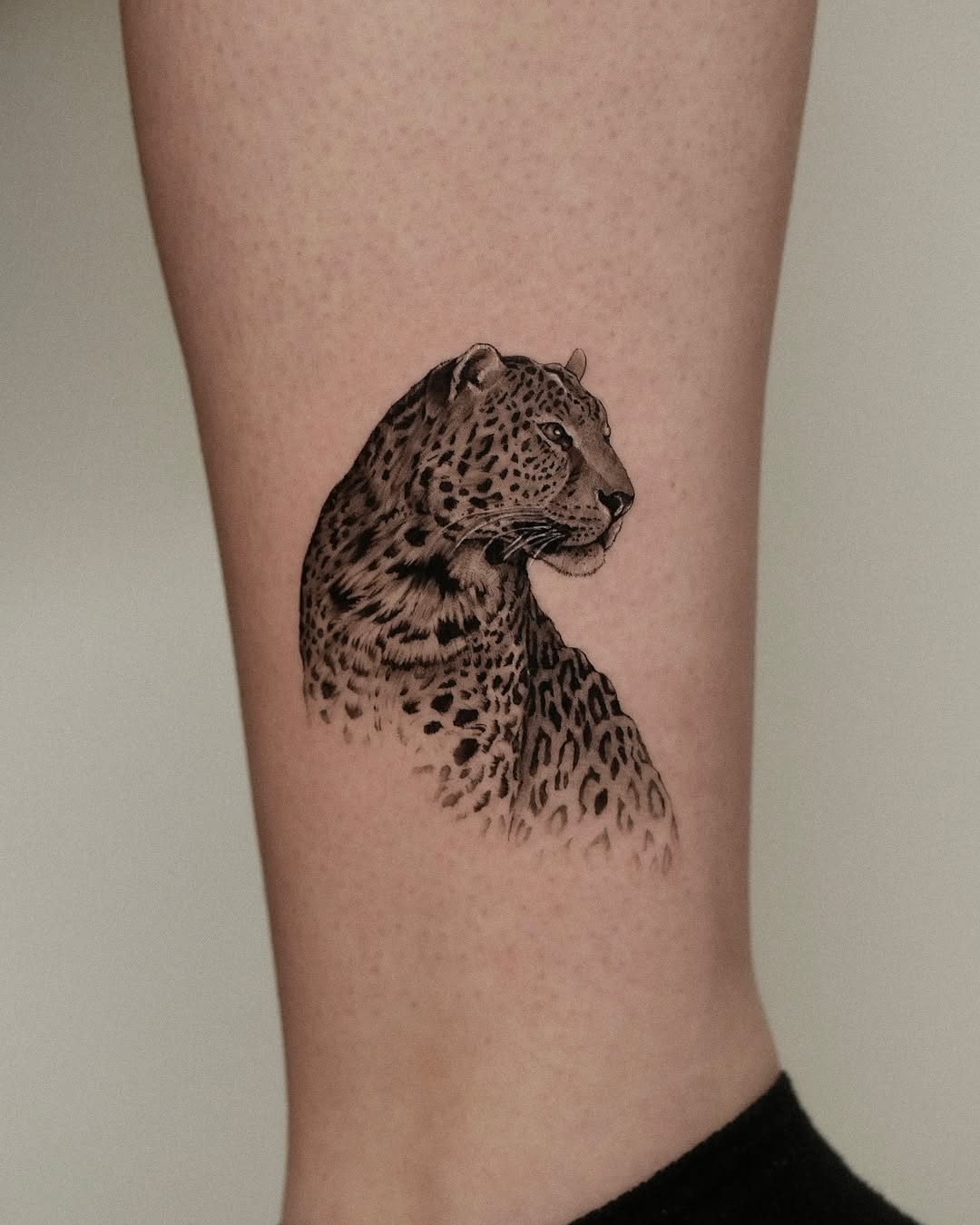 Elegant leopard tattoo showcasing fierce beauty