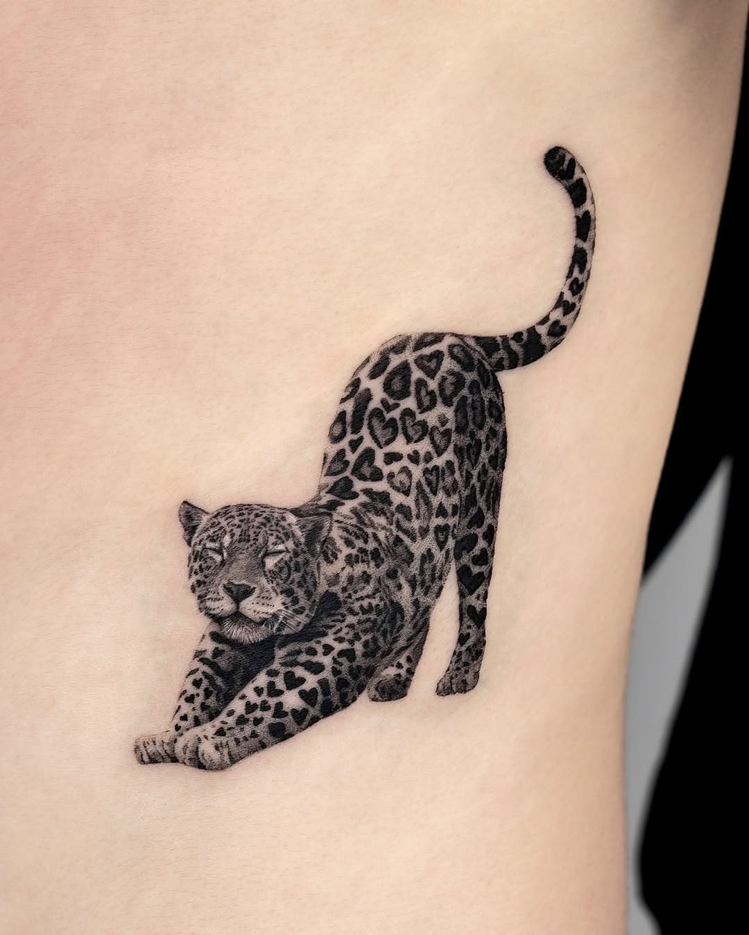Elegant stretching leopard tattoo design