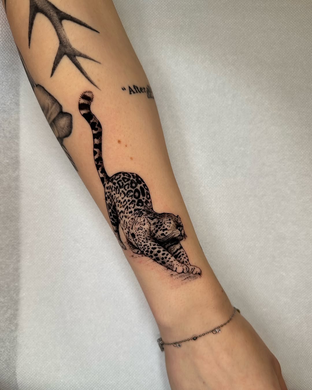Playful leopard tattoo showcasing feline grace