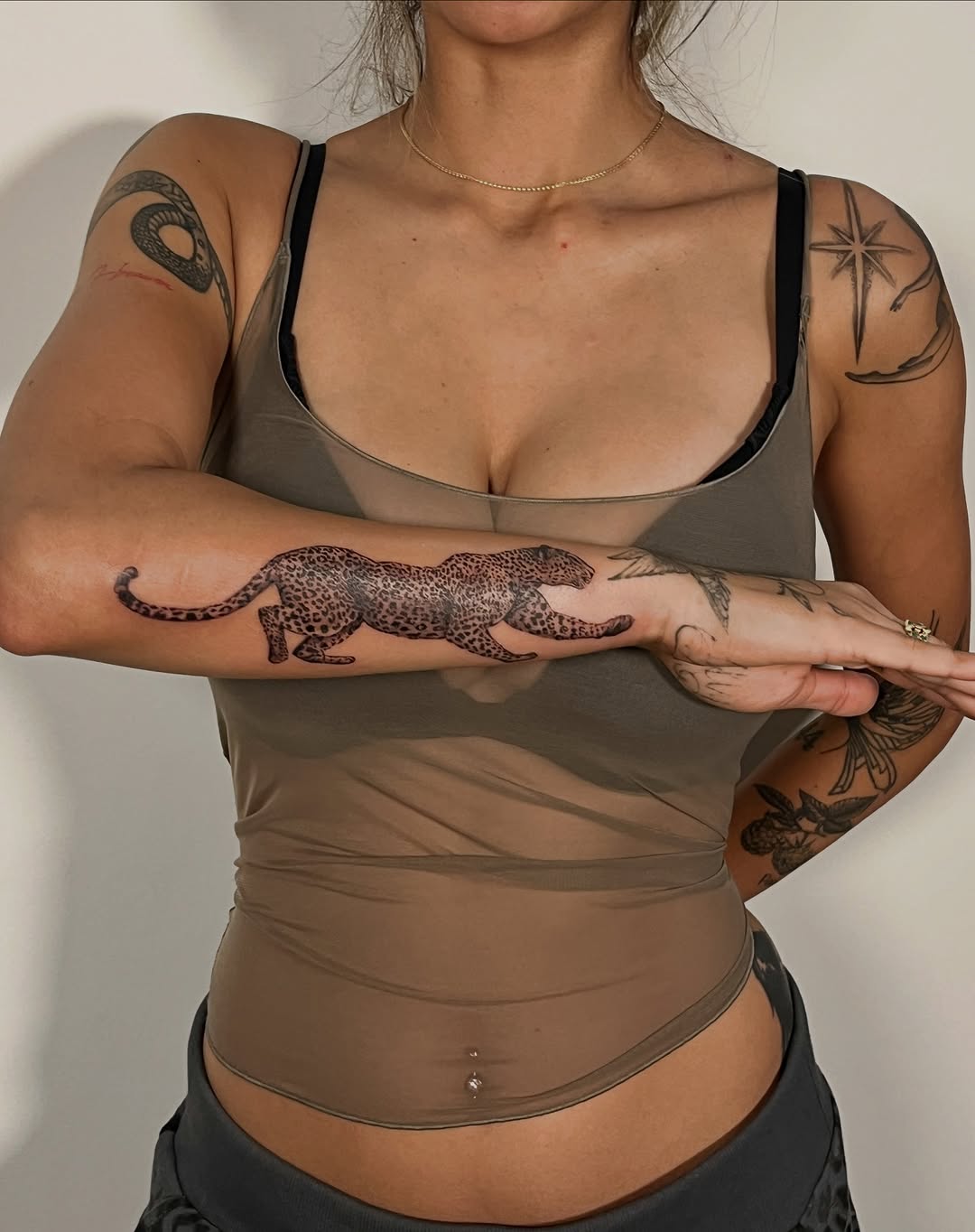 Elegant leopard tattoo on a woman's arm