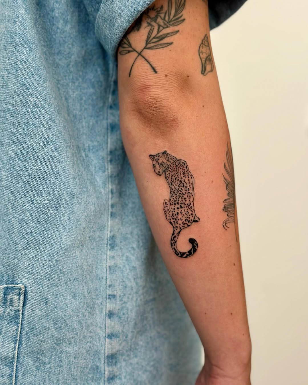 Stylish leopard tattoo on a forearm