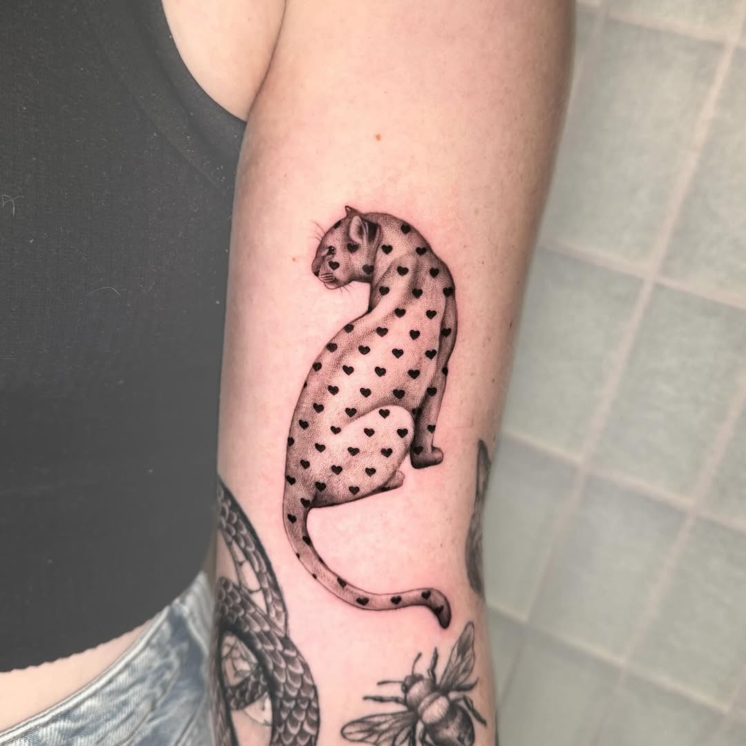 Stylish leopard tattoo with heart motifs